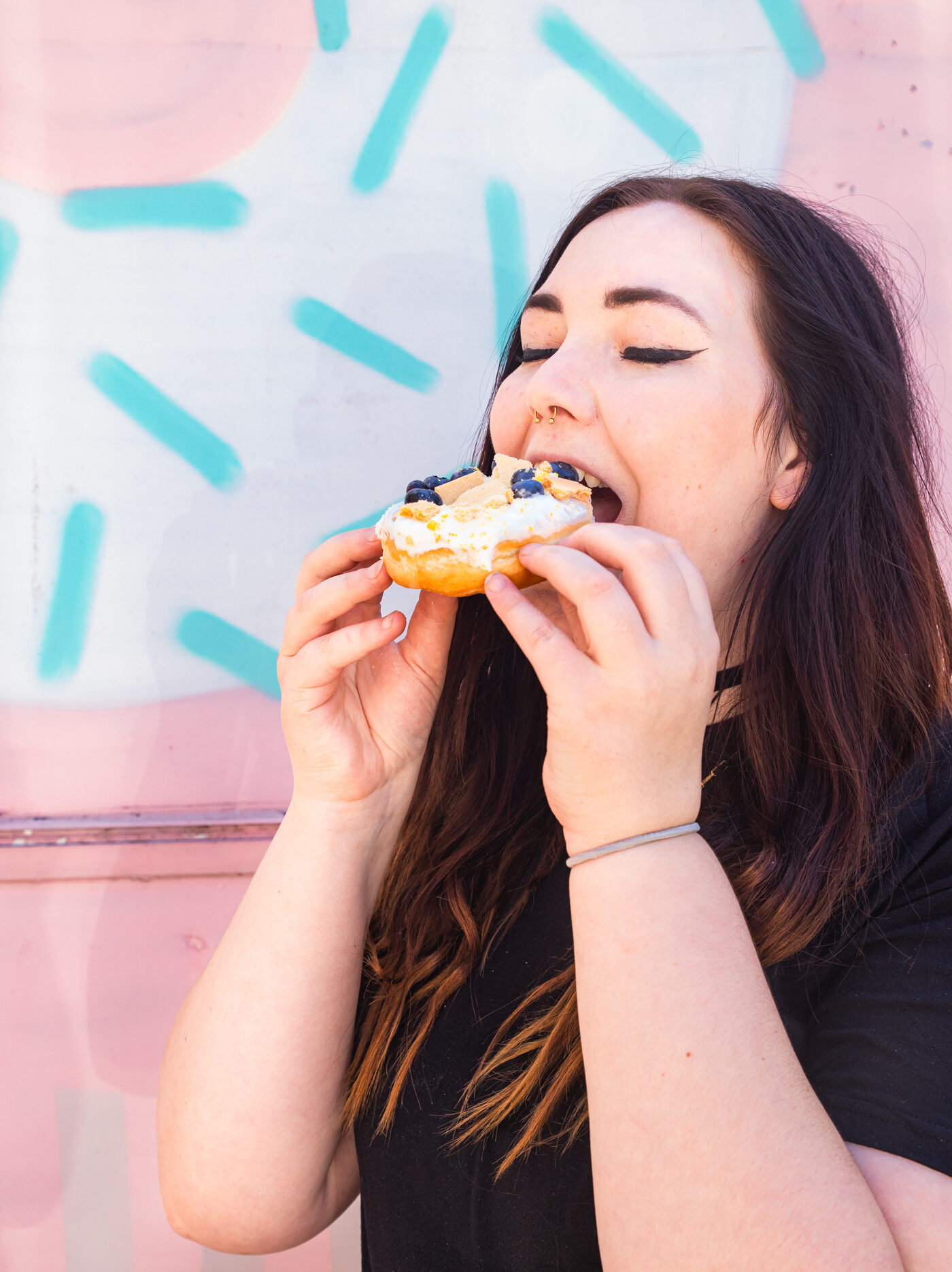 Melanie eating a blueberry donut.